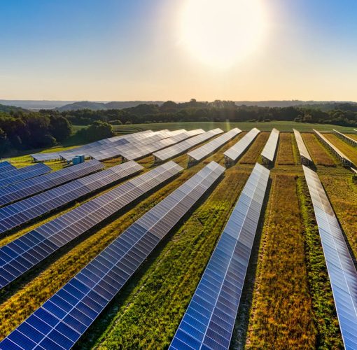 Aerial view of a solar farm in Red Wing, MN, with solar panels harnessing the sun's energy.